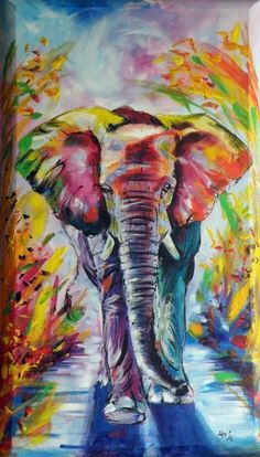 an elephant is walking down the street with colorful paint