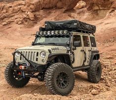 an off - road vehicle is parked in the desert