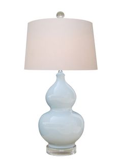 a table lamp with a white shade on it