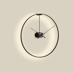 a clock that is on the wall with lights around it and an object in the middle