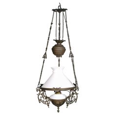 an old fashioned chandelier with a white shade hanging from it's side