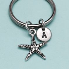 a starfish keychain with the letter a on it's front and bottom