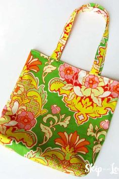 a green and yellow floral bag sitting on top of a white table