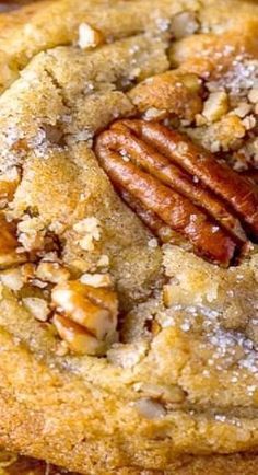 a close up of a cookie with pecans on top