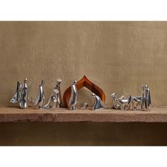 a group of metal figurines sitting on top of a wooden table