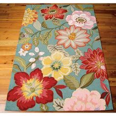 a blue rug with colorful flowers on it