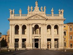 an old building with statues on the front and side of it's entrance way