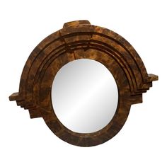 a round mirror sitting on top of a wooden table