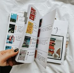 a person is holding an open book with pictures on it and writing in the pages