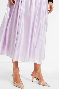 Feel whimsical and ethereal in the Lilac Bellamy Skirt. Featuring a sheeny material, elastic waistband, and pleated flowy body, this midi will look stunning when you move along the dance floor. Pair with a white tank and raffia heels for a seasonal social event or with a black fitted blouse and gold jewelry for a night at the theater. High rise Elastic waistband Pleated body Flowy A-line silhouette Lined Fabric has a sheen Material: Care: Hand wash cold, do not bleach, hand to dry, low iron Fitted Blouse, Social Event, Move Along, Cocktail Attire, Fitted Blouses, Color Crush, Weekend Wear, Low Iron, The Dance