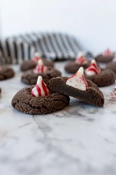 chocolate cookies with white and red candy canes on top