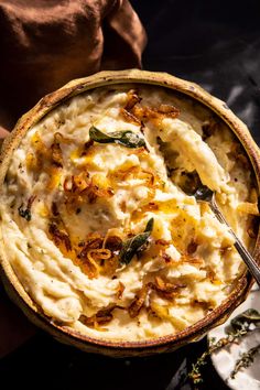 a bowl filled with mashed potatoes on top of a table