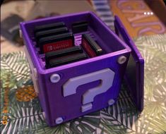 a purple toy box with question marks on it