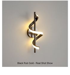 the black rub gold - real shot show logo is displayed on a white wall with a spiral design