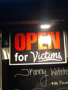 an open for victims sign on the side of a building