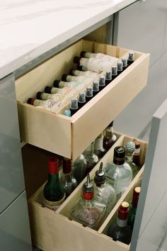 an open drawer with bottles in it