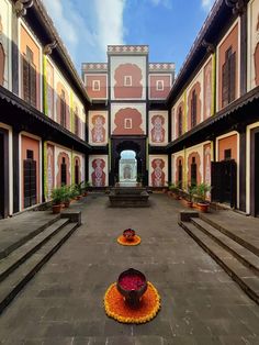 an empty courtyard with steps leading up to it and potted plants on the ground