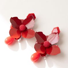 Fiery Blossom Statement Earrings | Red Floral Design These bold and striking red floral earrings are perfect for making a statement. Handcrafted with vibrant red metal petals and a detailed bead center, these earrings bring a touch of nature-inspired elegance to your look. The glossy finish gives them a modern, sleek appearance, while the rich red hue evokes passion and sophistication. Accented with teardrop-shaped beads, these earrings are lightweight and ideal for special occasions or adding a pop of color to everyday outfits. Key Features: Statement floral design in vivid red Glossy finish for a modern, eye-catching look Perfect for both casual and formal events Add a vibrant and unique accessory to your collection with these fiery floral earrings! Costume Earrings, Party Earrings, Earrings Red, Floral Earrings, Accessories Unique, Vibrant Red, Red Floral, Flower Earrings, Nature Inspired