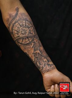 a man with a compass tattoo on his arm