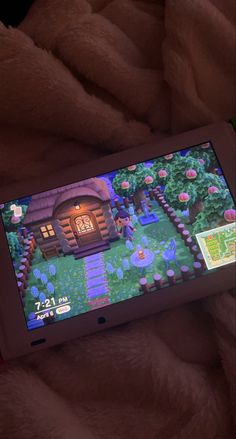 an image of a game on a tablet screen in someone's bed at night