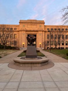 a large building with a statue in front of it