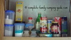 an open cabinet filled with lots of food and condiments on top of it