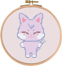 a cross - stitch cat is shown in the hoop