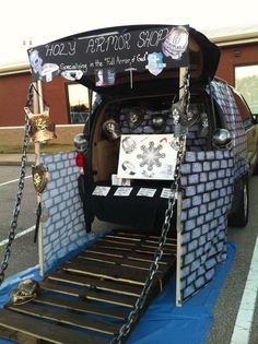 the back end of a van with a bed attached to it's sides and chains hanging from the side