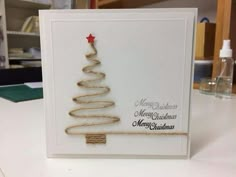 a white card with a christmas tree on it