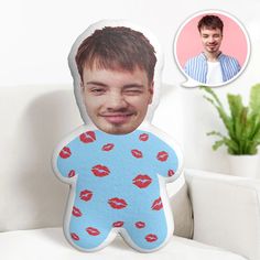 a pillow with a photo of a man's face and lips on it next to a couch