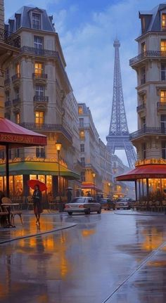 the eiffel tower is lit up in the distance as people walk down the street