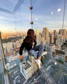 a woman standing on top of a tall building