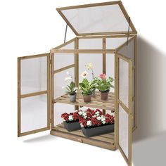 an open wooden greenhouse with flowers inside