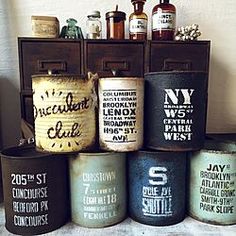 several old fashioned canisters are stacked on top of each other