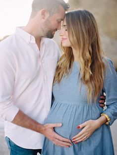 a pregnant couple standing next to each other