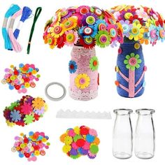 a vase filled with lots of colorful flowers next to some scissors and other crafting supplies