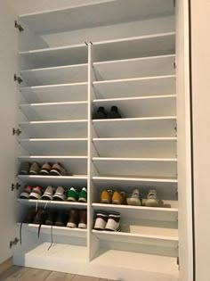 a white closet with several pairs of shoes on the bottom shelf and two rows of shelves below