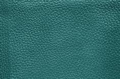 a close up view of the green leather texture