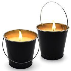 two black buckets filled with candles on top of each other and one has a candle in it