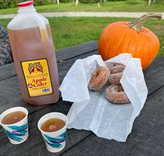 doughnuts, coffee and apple cider on a picnic table