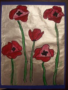 an art project with red flowers painted on the side of a piece of foil paper