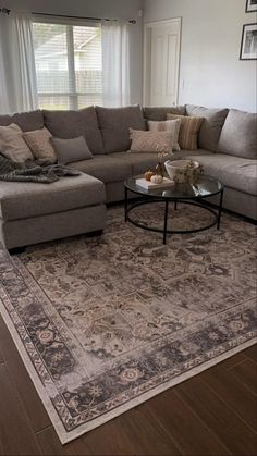 a living room filled with furniture and a large rug