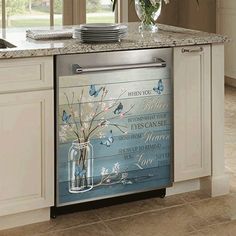 a dishwasher in a kitchen next to a window with flowers and butterflies on it