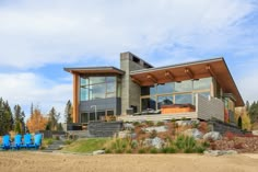 a large house sitting on top of a sandy beach