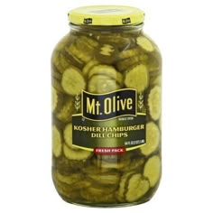 a jar filled with pickles sitting on top of a table