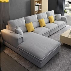 a large sectional couch with yellow pillows in a living room