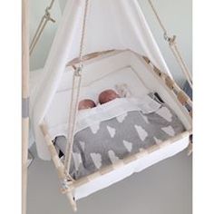 a baby is laying in a hammock bed