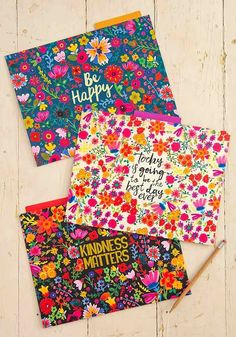 three greeting cards with colorful flowers and the words be happy written on them, sitting next to each other