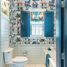 a bathroom with blue shutters and palm trees on the wall