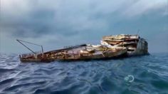 an old boat sitting on top of the ocean under a cloudy sky with dark clouds